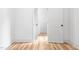 Hallway featuring modern doors, light colored walls, and wood flooring at 1040 Southern High School Rd, Burlington, NC 27215