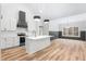 Modern kitchen with stainless steel appliances, white cabinetry, and a stylish island with seating at 1040 Southern High School Rd, Burlington, NC 27215