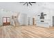 Spacious living area with wood floors, high ceilings, and a modern kitchen in the background at 1040 Southern High School Rd, Burlington, NC 27215