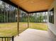Covered back porch with stained wood ceiling and expansive backyard at 1040 Southern High School Rd, Burlington, NC 27215