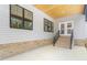 Spacious patio with brick base, wood ceiling, black trimmed windows and door to interior at 1040 Southern High School Rd, Burlington, NC 27215