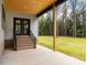 Covered patio with brick steps and access to the backyard at 1040 Southern High School Rd, Burlington, NC 27215