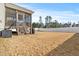 Screened porch with wooden steps and grill at 105 Virginia Creek Dr, Holly Springs, NC 27540