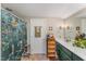 Bathroom featuring a floral shower curtain, green vanity, and decorative accents at 110 E Orange St, Hillsborough, NC 27278