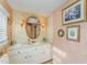 Charming bathroom with peach accents, floral wallpaper, and a vanity with ample storage at 110 E Orange St, Hillsborough, NC 27278