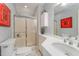 Clean bathroom with a glass-enclosed shower, white tile, and ample counter space at 110 E Orange St, Hillsborough, NC 27278
