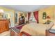 Cozy bedroom with hardwood floors, a large window, and classic furniture at 110 E Orange St, Hillsborough, NC 27278
