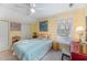 Inviting bedroom with yellow walls, a cozy bed, and ample natural light from the window at 110 E Orange St, Hillsborough, NC 27278