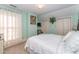 Calm bedroom with a white comforter, soft light, and view of a window at 110 E Orange St, Hillsborough, NC 27278
