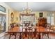 Elegant dining room with a chandelier, large window, and classic wood furniture at 110 E Orange St, Hillsborough, NC 27278