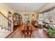 Formal dining area featuring a large wooden table, hardwood floors, and chandelier at 110 E Orange St, Hillsborough, NC 27278