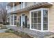 Charming home featuring bay windows, black shutters, and a welcoming stone walkway at 110 E Orange St, Hillsborough, NC 27278