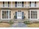 Two-story house with double front doors, stone patio, and bay windows at 110 E Orange St, Hillsborough, NC 27278