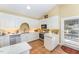 Well-lit kitchen with stainless steel appliances, white cabinetry, and tile flooring at 110 E Orange St, Hillsborough, NC 27278