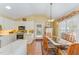 Bright kitchen with white cabinets, stainless steel appliances, and a breakfast nook with natural light at 110 E Orange St, Hillsborough, NC 27278