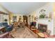 Warm and inviting living room featuring a fireplace, hardwood floors, and ample seating at 110 E Orange St, Hillsborough, NC 27278