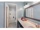 Full bathroom featuring shower-tub combo, updated vanity, and modern lighting at 112 Smith Rock Dr, Holly Springs, NC 27540