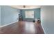 Bedroom with hardwood flooring, a ceiling fan, natural light, and calming blue walls at 112 Smith Rock Dr, Holly Springs, NC 27540