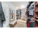 Walk-in closet with ample storage space, built-in shelving, and a dressing bench at 112 Smith Rock Dr, Holly Springs, NC 27540