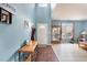 Foyer with hardwood floors and natural light leads to living room at 112 Smith Rock Dr, Holly Springs, NC 27540