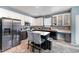 Modern kitchen with stainless steel appliances and island seating at 112 Smith Rock Dr, Holly Springs, NC 27540