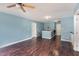 Spacious living room with hardwood floors, neutral paint, ceiling fan and staircase access at 112 Smith Rock Dr, Holly Springs, NC 27540