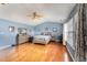 A primary bedroom features hard wood floors, a ceiling fan and lots of natural light at 112 Smith Rock Dr, Holly Springs, NC 27540