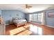 The primary bedroom features lots of natural light, hard wood flooring, and a vaulted ceiling at 112 Smith Rock Dr, Holly Springs, NC 27540