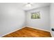 Simple bedroom with hardwood floors and a window at 124 W Cornwallis Rd, Durham, NC 27707