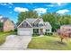 Two-story house with neutral siding, a three-car garage, and a landscaped yard at 1294 Fieldtrial Cir, Garner, NC 27529