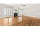 Living room with hardwood floors, fireplace, and French doors to patio at 1294 Fieldtrial Cir, Garner, NC 27529