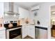 Modern kitchen with stainless steel appliances and white cabinets at 1309 Hudson Ave # D11, Durham, NC 27705