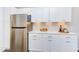 Stainless steel refrigerator with white shaker cabinets at 1309 Hudson Ave # D11, Durham, NC 27705