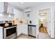 Modern kitchen with stainless steel appliances and white shaker cabinets at 1309 Hudson Ave # D11, Durham, NC 27705