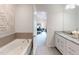 Elegant bathroom with granite vanity and large soaking tub at 1404 Hollyview Ave, Durham, NC 27703