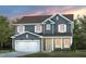 Two-story house with gray siding, white garage door, and landscaping at 1404 Hollyview Ave, Durham, NC 27703
