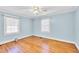 Bedroom with light blue walls, hardwood floors, and ceiling fan at 1606 Granville St, Burlington, NC 27215