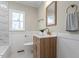 Modern bathroom with wood vanity, marble shower, and gold fixtures at 1606 James St, Durham, NC 27707