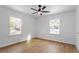 Spacious bedroom with light hardwood floors and ceiling fan at 1606 James St, Durham, NC 27707