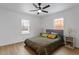 Spacious bedroom with wood floors, ceiling fan, and large windows at 1606 James St, Durham, NC 27707