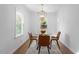 Modern dining area with glass top table and four brown leather chairs at 1606 James St, Durham, NC 27707