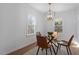 Bright dining room with a glass table and four leather chairs at 1606 James St, Durham, NC 27707