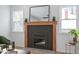 Modern fireplace with a dark mantel and light colored walls at 1606 James St, Durham, NC 27707