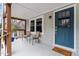 Inviting front porch with seating area, stylish blue front door, and 'Home Sweet Home' welcome mat at 1606 James St, Durham, NC 27707