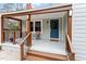 Cozy front porch with stylish lighting, seating, and a welcoming blue front door at 1606 James St, Durham, NC 27707