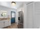 Modern kitchen with stainless steel refrigerator and white cabinets at 1606 James St, Durham, NC 27707
