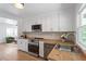 Modern kitchen featuring butcher block counters, white cabinets, and stainless appliances at 1606 James St, Durham, NC 27707