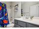 Bathroom with gray vanity, bathtub shower combo, and dinosaur theme at 165 Turlington Rd, Dunn, NC 28334