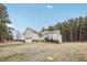 View of the home's exterior, showcasing the backyard and trees at 165 Turlington Rd, Dunn, NC 28334