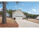 Side view of the house with garage and landscaping at 165 Turlington Rd, Dunn, NC 28334
